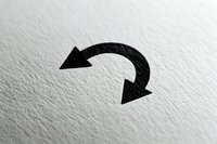 Black curved arrow symbol on white textured paper surface for business presentations and recycling concepts.