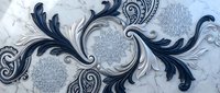 Elegant baroque ornamental pattern with flowing scrollwork and paisley motifs in navy blue and silver tones on marble texture background for luxury design.