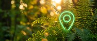 Green glowing location pin icon floating among lush fern leaves with warm golden bokeh lights creating magical forest atmosphere for navigation apps.