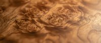 Natural wood grain texture with swirling patterns and knots showcasing rich brown tones and organic flowing lines for interior design and crafting projects.