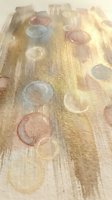 Abstract watercolor circles in warm earth tones with golden brushstrokes on textured paper background for artistic design projects and creative layouts.