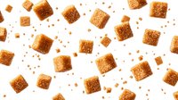 Brown sugar cubes and granules scattered on white background, floating in dynamic composition. Isolated sweet ingredients for food and beverage photography.