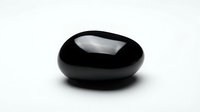 Black polished stone pebble with glossy surface isolated on white background for spa wellness meditation zen garden decoration and natural therapy concepts.
