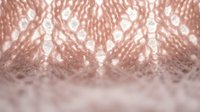 Rose gold sequin fabric texture with sparkling metallic surface and bokeh light effects for luxury fashion and glamorous party backgrounds.