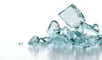 Pile of transparent ice cubes with blue tint on reflective white surface, creating cool refreshing atmosphere for beverage and food photography.