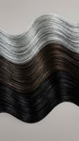Flowing wavy hair texture with natural color gradient from dark brown to silver gray showcasing healthy shine and movement for beauty salon concepts.
