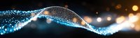 Glowing blue particle wave with bokeh light effects on dark background creates dynamic flowing motion and energy visualization for technology concepts.