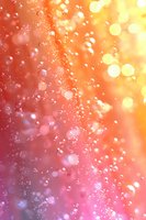 Magical bokeh background with floating water drops and bubbles in pink and golden colors creating dreamy atmospheric effect for romantic designs.