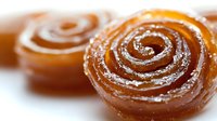 Golden spiral pastry rolls dusted with powdered sugar on white background, fresh baked cinnamon swirl dessert for bakery menu and food photography.