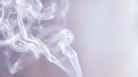 Ethereal white smoke wisps swirl against soft lavender and pale background, creating abstract flowing patterns. Suitable for wellness, spirituality, meditation, and design overlays.