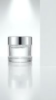 Luxury glass cosmetic jar with silver lid on white background for skincare cream moisturizer anti-aging product packaging design mockup.