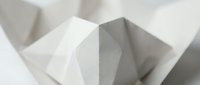 Abstract geometric paper sculpture with angular white folded forms creating dramatic shadows and depth for modern minimalist design projects.