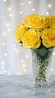 Fresh yellow roses in crystal vase with warm bokeh lights creating romantic atmosphere for home decor and special occasions.
