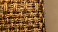Natural woven jute rope texture with detailed fiber pattern. Rustic braided hemp material background for eco-friendly craft and home decor projects.