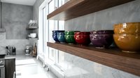 Colorful ceramic jars arranged on wooden shelves in modern kitchen with concrete walls and natural light from windows, storage and home decor.