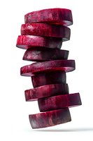 Fresh beetroot slices stacked in artistic tower formation on white background, isolated for culinary design projects and healthy food concepts.