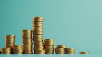 Stacked gold coins forming bar graph against turquoise background, representing financial growth, investment success, and economic concepts.