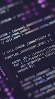 Programming code on computer screen with purple and pink syntax highlighting showing software development and web application coding work.