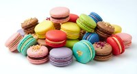 Colorful French macarons in various flavors scattered on white background. Sweet pastry dessert cookies with cream filling for bakery menu design.