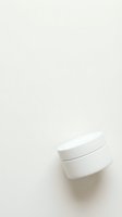 White ceramic bowls stacked on neutral beige background with soft shadows creating minimalist kitchen composition for culinary and home decor projects.