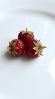 Fresh ripe strawberries with green leaves on white background for healthy eating, organic food concepts and culinary designs.