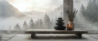 Zen meditation setup with stacked stones, candle and lavender on wooden table overlooking misty mountain forest landscape for mindfulness and relaxation practices.