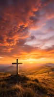 Wooden cross silhouette on hilltop against dramatic orange sunset sky with rolling hills landscape for spiritual and religious themes.