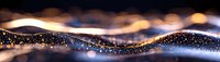 Abstract flowing waves of golden light and glowing particles against dark background create mesmerizing pattern with bokeh effect and sparkles.