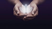 Male hands holding glowing lotus flower symbol against dark background, representing spirituality, meditation, wellness, healing, mindfulness and inner peace.