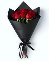 Elegant bouquet of vibrant red roses wrapped in black paper with satin ribbon, perfect for romantic occasions, anniversaries, or luxury gift presentations.