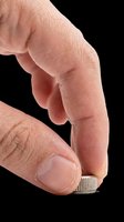 Finger holding small metal screw isolated on transparent background, ready for design use in clipart, print-on-demand products, stickers, and sublimation projects.
