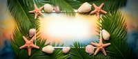Tropical summer frame with palm leaves, seashells and starfish on sandy beach background for vacation design and travel promotions.
