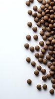 Chocolate cereal balls scattered on white background with copy space for breakfast and healthy eating concepts.