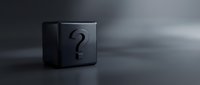 Black cube with question mark symbol on dark surface with dramatic lighting and shadows creating mystery and uncertainty concept.