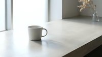 Minimalist ceramic mug on modern marble countertop with natural light from window, suitable for lifestyle, home decor, and beverage product marketing.