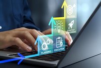 Business professional using laptop with digital strategy icons showing planning execution and success growth arrows for corporate development.