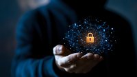Businessman holding glowing digital network with golden padlock symbol representing cybersecurity data protection and secure technology solutions.
