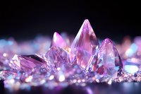 Pink crystal formations with translucent peaks against dark background, glowing with ethereal light and bokeh effects, creating magical mineral atmosphere.