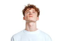 Young Caucasian male with curly brown hair looking upward with contemplative expression wearing white t-shirt against white background, isolated studio portrait.