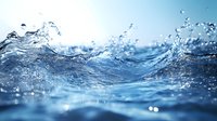 Dynamic ocean wave with splashing water droplets and ripples against bright blue sky, captured in macro detail with soft bokeh effect and crystal clear motion. For nature and environmental designs.