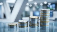 Stack of coins arranged in ascending order showing financial growth and investment progress in modern office environment with blurred background.
