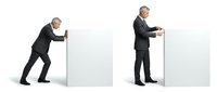 Businessmen in suits pushing and pulling white blocks in teamwork concept for corporate collaboration and problem-solving strategies.