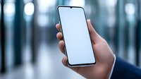 Hand holding modern smartphone with blank white screen against blurred blue background, mockup for app or website presentation in business environment.