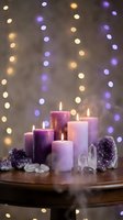 Purple candles burning with amethyst crystals and bokeh lights creating peaceful meditation atmosphere for wellness spa relaxation and spiritual healing rituals.