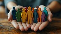 Hands holding colorful paper cutout figures representing diversity, teamwork, community support, inclusion and human resources management concepts.