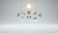 Glowing light bulb with business icons representing innovation, finance, growth, and entrepreneurship on clean white background for corporate design.