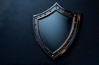 Metal shield with riveted frame on dark background, dramatic lighting creates protective security concept for business and defense applications.