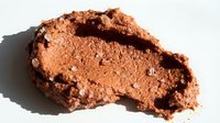 Crushed cocoa powder isolated on white background, suitable for food photography, baking design projects, and culinary content creation.
