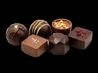 Six assorted gourmet chocolate pralines isolated on transparent background, ready for T-shirt design, stickers, clipart, print on demand, and sublimation projects.