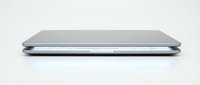 Closed laptop computer with silver metallic finish displayed in side profile view against neutral background, suitable for technology and business design projects.